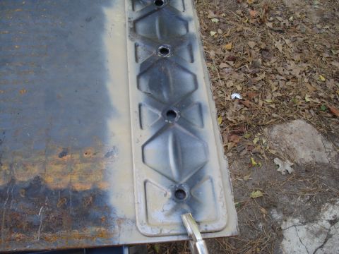 1991 Ford Bronco - Close-up of an engine valve cover, showing its distinctive diamond pattern and bolt holes.