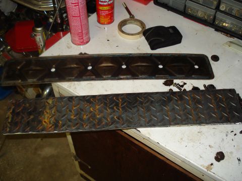 1991 Ford Bronco - Workbench setup with engine parts and tools, including a valve cover and diamond plate.