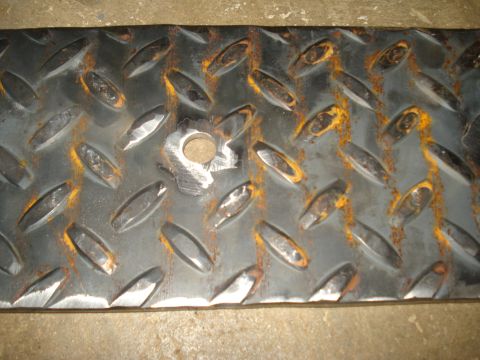 1991 Ford Bronco - Close-up of rusted diamond plate metal, showing wear and a hole. Supermotors.net logo visible.