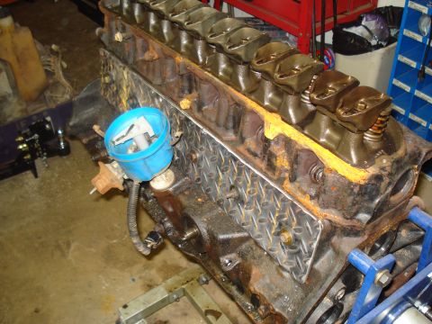 1991 Ford Bronco - Close-up view of an engine block, a blue distributor cap and its internal components.