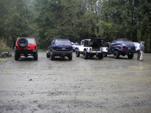 2005 Jeep Wrangler - Several Jeeps are parked in a lot, some with their rear doors open.
