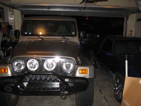 2005 Jeep Wrangler - A 2005 Jeep Wrangler is parked in a garage alongside a Ford Mustang.