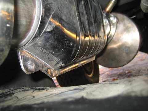 1996 Ford Bronco - Underside view of a vehicle's exhaust system part, showing chrome finish and ribbed texture.