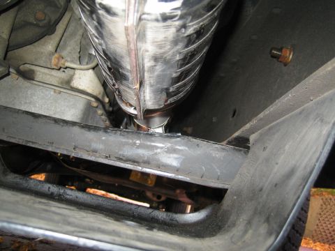 1996 Ford Bronco - A close-up view of the exhaust system and undercarriage of a vehicle.