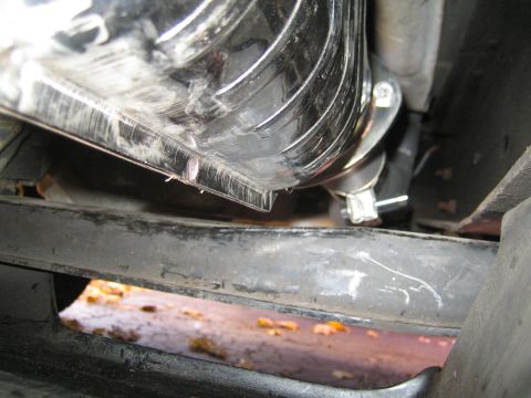 1996 Ford Bronco - Close-up view of a chrome exhaust pipe with a clamp and black hose attached.
