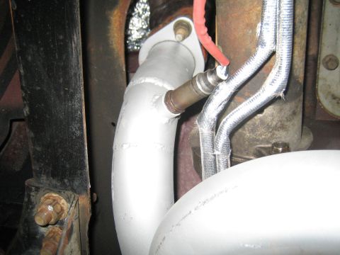 1996 Ford Bronco - Close-up view of a vehicle's exhaust system, showing an oxygen sensor and piping.