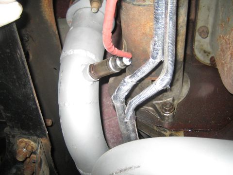 1996 Ford Bronco - Exhaust pipe and oxygen sensor detail, likely from a vehicle's undercarriage.