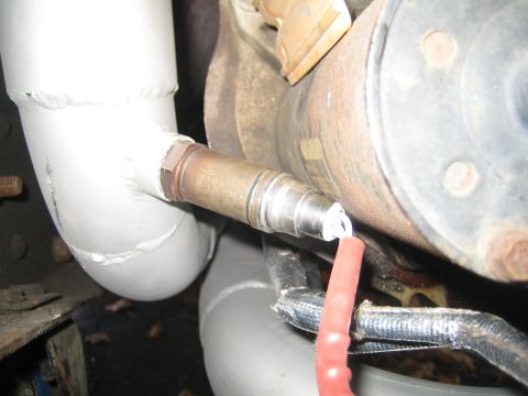 1996 Ford Bronco - Close-up view of an oxygen sensor installed on a vehicle's exhaust system.