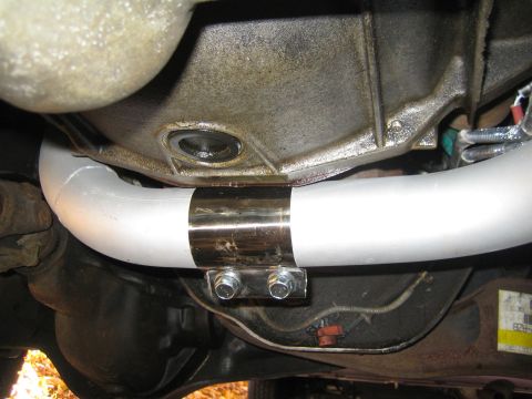 1996 Ford Bronco - Close-up view of an exhaust pipe section with a clamp, likely part of a vehicle's undercarriage.