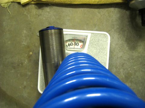 1996 Ford Bronco - A blue hose and a metal cylinder rest on a bathroom scale, which reads 60.