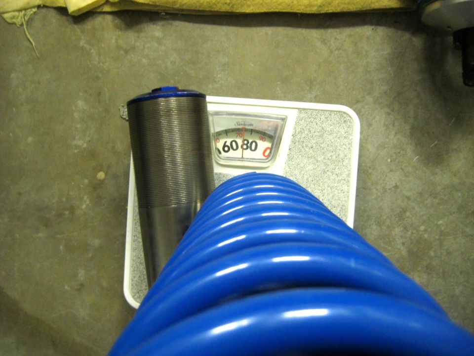 Blue hose and metal cylinder on a scale showing 60