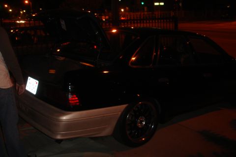 1993 Ford Taurus - Rear view of a 1993 Ford Taurus with its trunk open, a two-tone paint scheme.