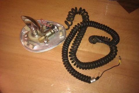 1991 Ford Crown Victoria - This is a police spotlight with a coiled cord, likely a police equipment part.
