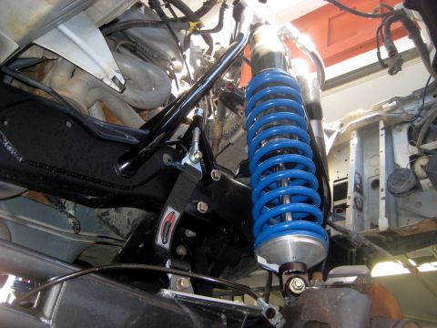 1996 Ford Bronco - Close-up of a blue coilover shock absorber and suspension hardware.