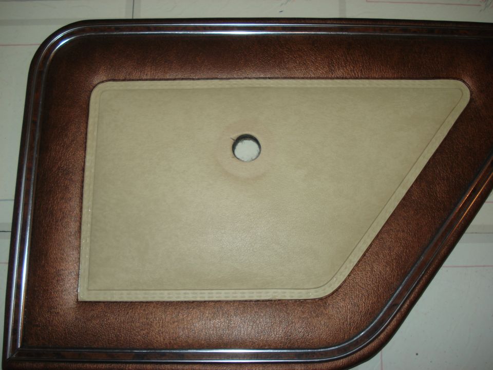 Brown and tan car door panel with a hole in the center