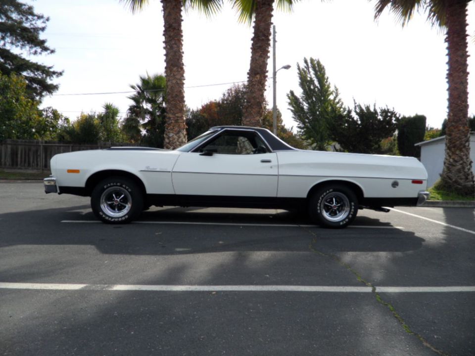 White 1973 Ford Ranchero parked in a lot, side view, black trim, aftermarket wheels
