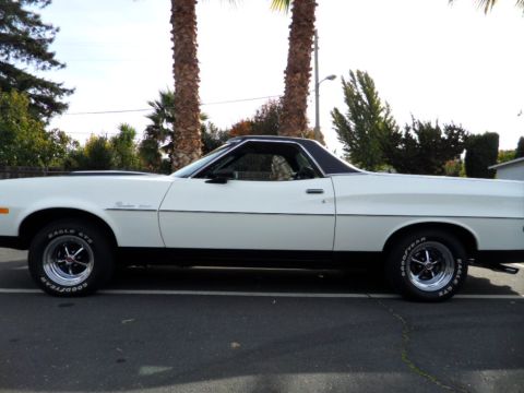 1973 Ford Ranchero - Side profile of a 1973 Ford Ranchero, a white exterior with black accents and a black vinyl roof.