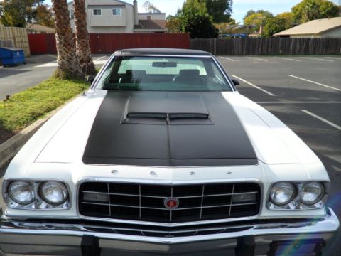 1973 Ford Ranchero - This 1973 Ford Ranchero features a distinctive black hood stripe and scoop, seen from a front-facing perspective.