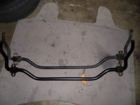 1973 Ford Ranchero - Two automotive sway bars are shown side-by-side on a mat, possibly for comparison or replacement.