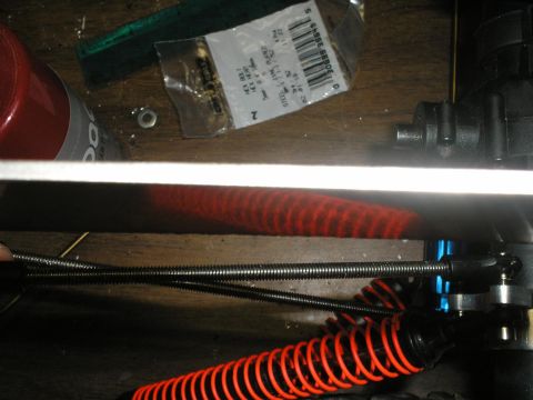 1994 Ford Escort - Close-up of RC car suspension parts, including springs and linkages.