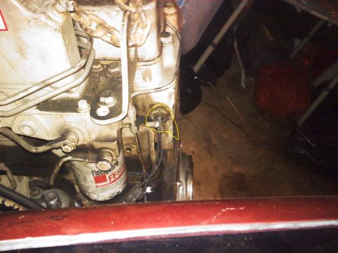 1990 Ford Bronco - This image shows a close-up of an engine's oil filter and surrounding components, with a sensor circled in yellow.