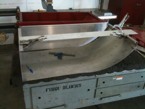 1986 Chevrolet Blazer - A metal sheet is being shaped on a workbench labeled 'FORM BLOCKS', secured with clamps.
