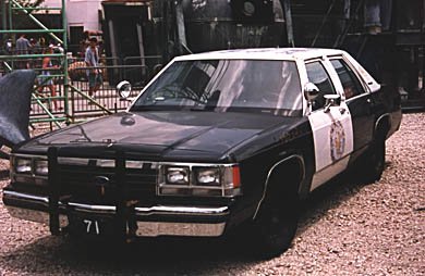1991 Ford Crown Victoria - This 1991 Ford Crown Victoria police car is seen from the front-three-quarter view, with a license plate reading '71'.
