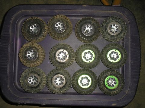1994 Ford Escort - A collection of off-road RC car tires are neatly arranged on a purple tray, ready for use.