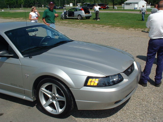 Silver New Edge Mustang convertible front three-quarter view at outdoor car event