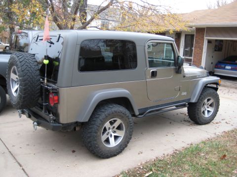 2005 Jeep Wrangler - This 2005 Jeep Wrangler features a two-tone paint scheme with a grey hardtop and Rubicon badging, viewed from the front three-quarter angle.