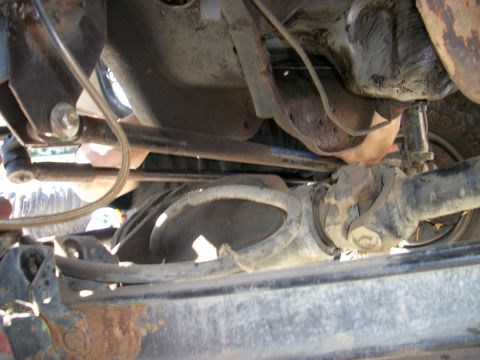 1969 Ford F-250 - The underside of a vehicle shows its suspension and drivetrain components.