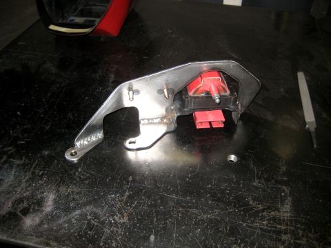 1996 Ford Bronco - A custom metal bracket is shown holding a red ignition coil, likely a vehicle part.