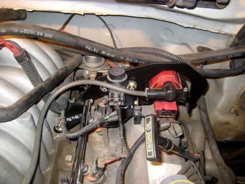 1996 Ford Bronco - Close-up view of an engine bay, showing the ignition coil, fuel injectors, and an "ENGINE OIL" dipstick.