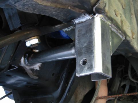 1985 Ford Bronco - Custom suspension bracket with visible welds and a large bolt is shown in this close-up view.