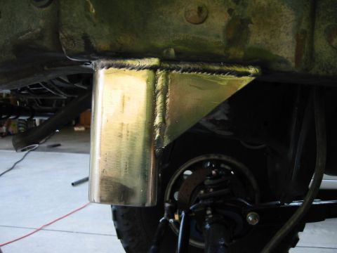 1985 Ford Bronco - Custom welded bracket installed on vehicle frame, showing suspension components and tire.