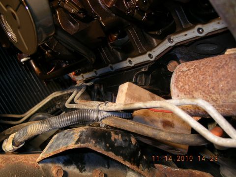 1997 Ford F-250 - Close-up view of a vehicle's engine bay, showing mechanical parts and signs of wear.
