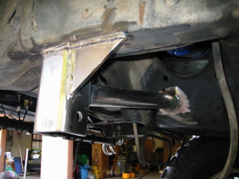 1985 Ford Bronco - Custom suspension parts are welded to the frame of a vehicle, indicating a modification.