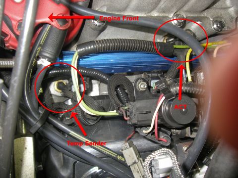 1990 Ford Bronco - This image shows various sensors and wiring harnesses within an engine compartment, with specific components labeled.