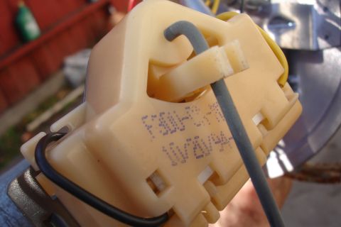 1990 Ford Taurus - Fuel pump assembly with visible part numbers stamped on the plastic housing.