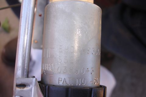1990 Ford Taurus - This image shows a close-up of a fuel pump with various part numbers and patent information etched into its casing.