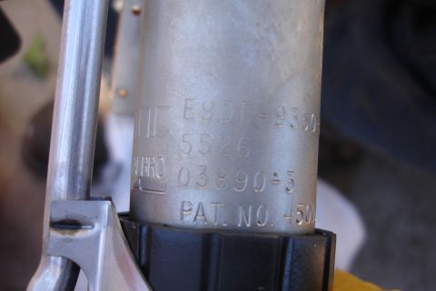 1990 Ford Taurus - Close-up of a metal fuel pump part showing various stamped identification numbers and a patent number.