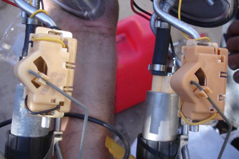 1990 Ford Taurus - Two fuel pump assemblies are shown, with readable part numbers visible on the beige plastic components.