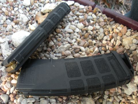 1996 Ford Bronco - Two rifle magazines, one loaded, are shown on a bed of small stones and dirt.