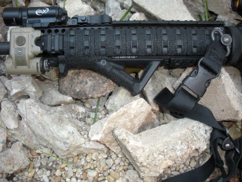 1996 Ford Bronco - Close-up of an assault rifle foregrip "LIVE FREE OR DIE" text and attached tactical light.