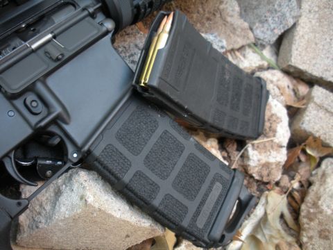 1996 Ford Bronco - AR-15 rifle with two loaded magazines on a rocky surface.