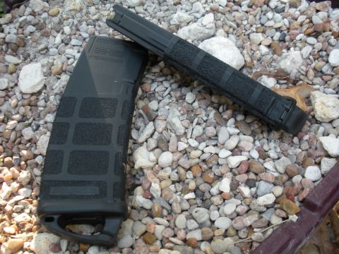 1996 Ford Bronco - Two black rifle magazines and a foregrip are displayed on a gravel surface.