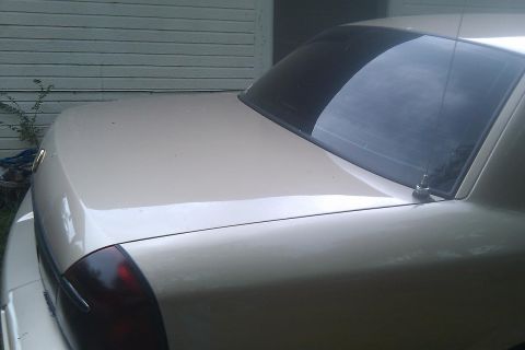 2000 Mercury Grand Marquis - The rear of a beige 2000 Mercury Grand Marquis is visible, showing its trunk and taillight.