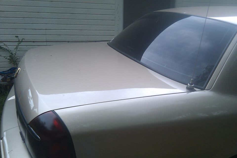Rear of a beige 2000 Mercury Grand Marquis with tinted windows