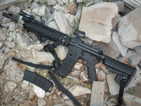 1996 Ford Bronco - An AR-style rifle with tactical accessories is displayed on a rocky surface.
