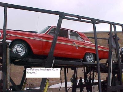 1969 Ford Torino - A red 1963 Ford Fairlane 500 is being transported on a car carrier.